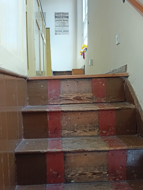 The wooden upper steps into the gallery